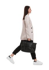 Beautiful businesswoman in suit with briefcase walking on white background