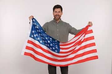 4th of July - Independence Day of USA. Happy man with American flag on white background