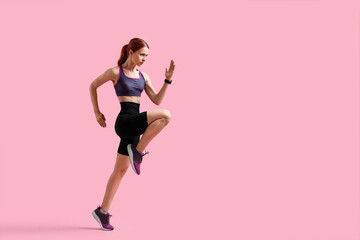 Fototapeta na wymiar Young woman in sportswear running on pink background, space for text