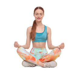 Young woman in sportswear meditating on white background
