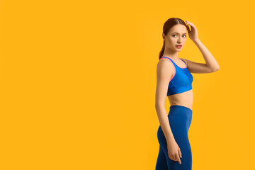 Young woman wearing sportswear on yellow background, space for text