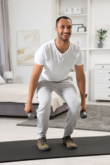 Man doing morning exercise on fitness mat at home