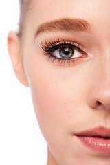 Beautiful eye with eyebrow and lashes on half face of attractive young woman.