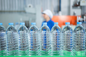 Drinking water factory worker at a production line of drinking water factory