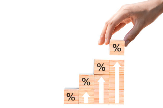 wooden block with percentage sign and arrow pointing up. isolated on white background. Concepts of returns from stocks, mutual funds, interest rates and dividends.PNG