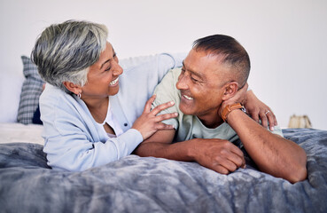 Love, bedroom and laughing senior couple bonding, happy and enjoy quality time together, funny...