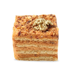 Piece of delicious layered honey cake on white background