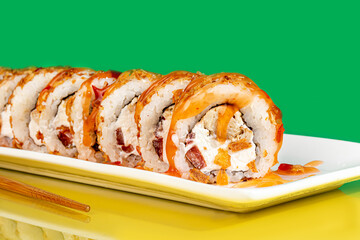 Sushi sets, rolls with caviar, shrimp, tuna and avocado and Philadelphia cheese, on a white plate.