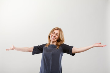 woman smiling to you with open arms as in an embrace