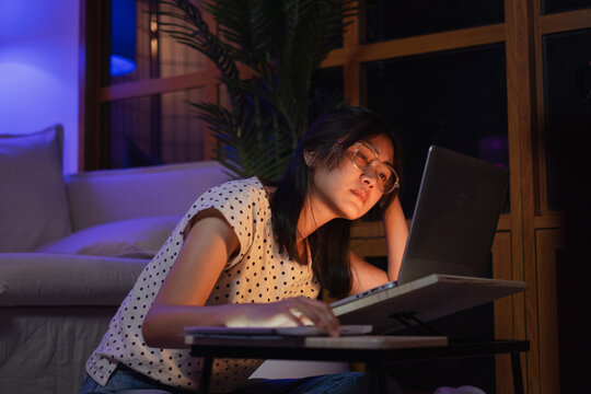 Young Asian Female Freelancer Or Student Is Working Late At Night. Concept Of Overload, Overworked And Burn Out Of Work. Tired, Exhausted, Fatigue And Sleepy From Working In Front Of Laptop. Deadline.