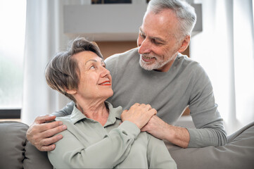 Smiling mature couple looking to each other and hugging
