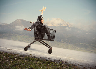 Crazy businessman like a child plays with a wood plane toy on a shopping cart