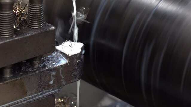 The lathe machine finish cut  large size metal shaft parts with liquid coolant method.