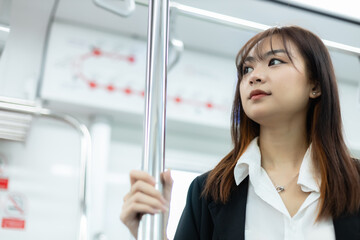 young asia women working lifestyle travel by train public transportation. Office female commuting...