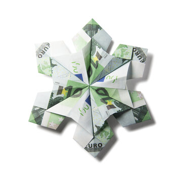 snowflake origami made of banknotes on a white background. Handmade