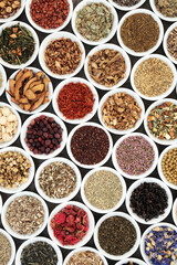 Herbal tea selection for good health in white porcelain bowls forming a background. Used also in natural alternative medicine.