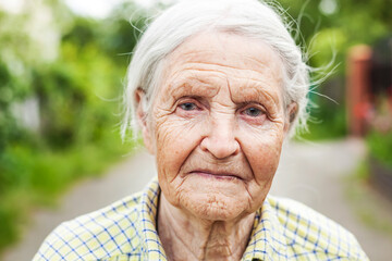 Portrait of an aged woman smiling outdoors