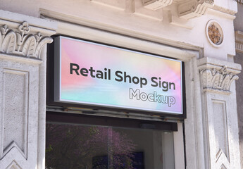 Modern Retail Sign Mockup with Reflections on a Classic Building