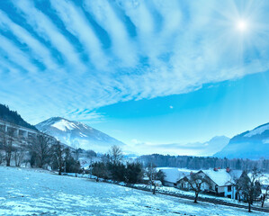 Winter mountain sunshiny village hazy landscape (Austria).
