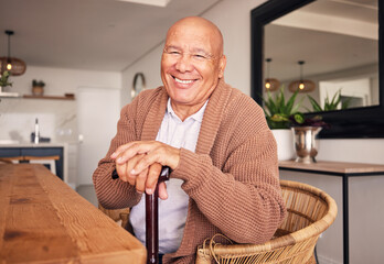 Portrait, walking stick and a senior man with a disability sitting in the living room of his home...