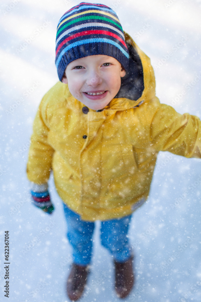 Poster little boy enjoying winter time and ice skating at outdoor rink