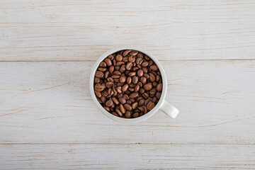 Cofee beans mug on white wood board