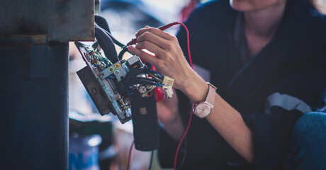 Electrical engineer checking Power Distribution Cabinet in the control room for industrial...