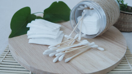 Fototapeta na wymiar Close-up cotton pads and sticks lie on the table near the jar