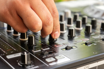 DJ Hands creating and regulating music on dj console mixer in concert party outdoor openair
