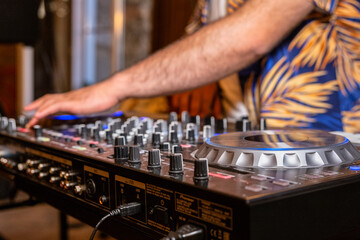 Fototapeta premium DJ Hands creating and regulating music on dj console mixer in concert party outdoor openair