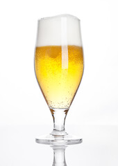 Glass of beer cider with foam golden color on white background