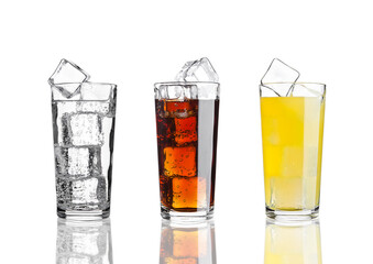 Glasses of cola orange soda lemonade with ice on white background with reflection