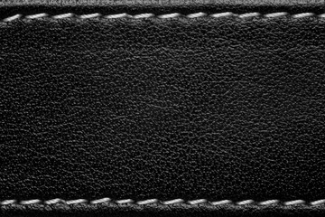 black leather background with white thread seam