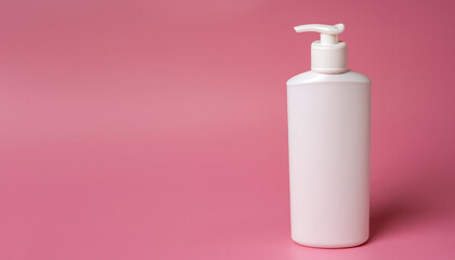 White bottle of moisturizing lotion on pink background with copy space. Minimalism style. Skin care, body treatment, beauty concept