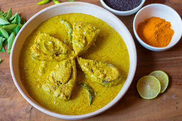 selective focus of Illish or Hilsa fish cooking with mustard seed.famous in India and Bangladesh. 