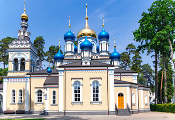 Fototapeta na wymiar Church of Our Lady of Kazan of the Mother of God with blue and gold domes in Dzintari, Jurmala, Latvia. 