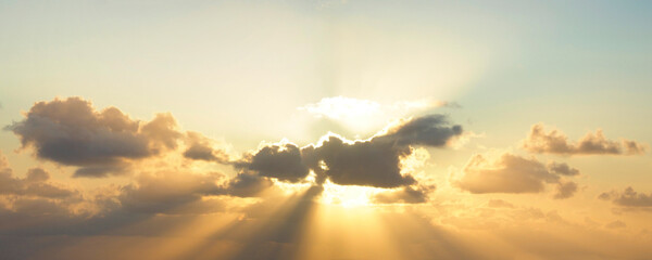 Panorama of the Sun Setting Behind Beautiful Golden Clouds - 622378878