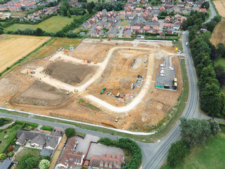 Aerial view of a large housing development construction site. Seen adjacent to a recently completed...