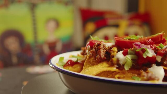 Eating Traditional Mexican food, tex mex cuisine nachos served with meat and vegetables, Taking cooked quesadilla from wooden tray, hot chilli salsa with guacamole top view.