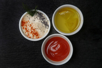 Different sauces and dips in bowls on the restaurant table

