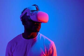 african american man playing video game in virtual reality glasses in neon lighting, the guy uses...
