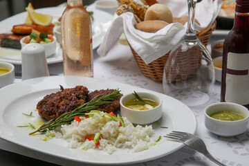Fried meatballs served with white rice and rosemary on the restaurant table	