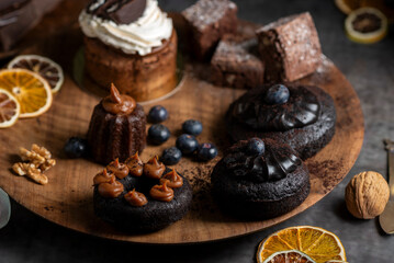 cakes puddings and chocolate muffins with blueberries and cream cherries and slices of dried citrus...