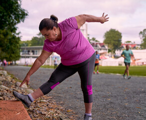 Obraz na płótnie Canvas Exercising Flexibility: Stretching on the Athletic Track