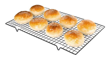 Cooling rack with tasty scones prepared on soda water isolated on white