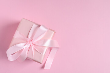 Gift box on pink background, top view. Space for text