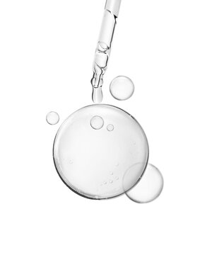 soft water bubble or cosmetic liquid serum drops with laboratory glass pipette on white background