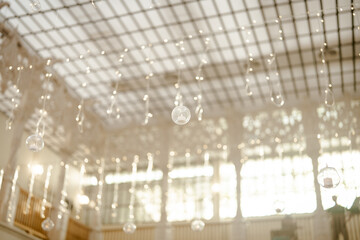 Lovely lanterns decorate the ceiling at a wedding.