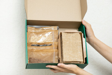 A set for growing sprouts from seeds. Box in hands