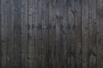 Vertical black dark burned wood vertical linear pattern facade. 